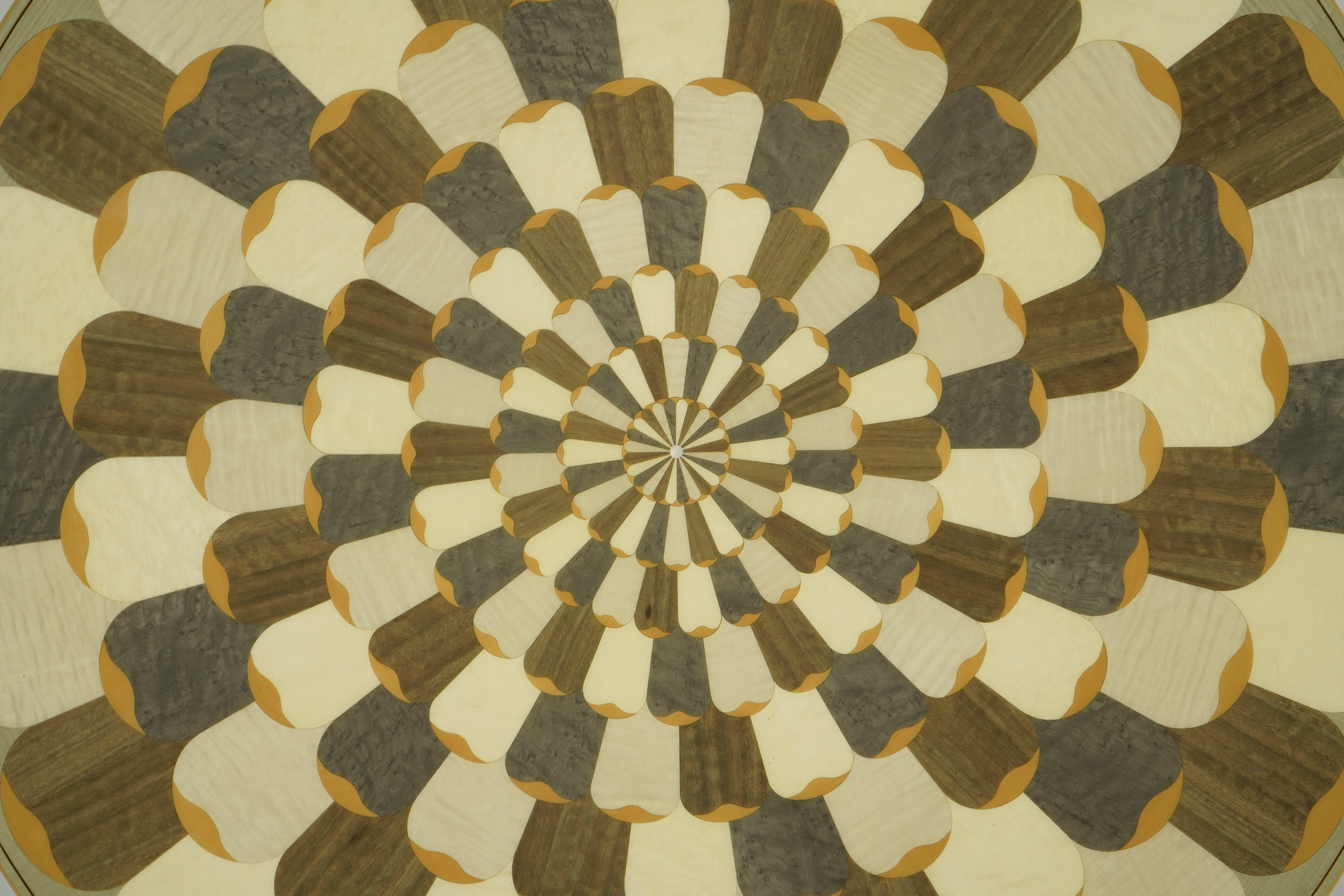 Lignae: A contemporary chrysanthemum and specimen wood inlaid circular tilt top centre table